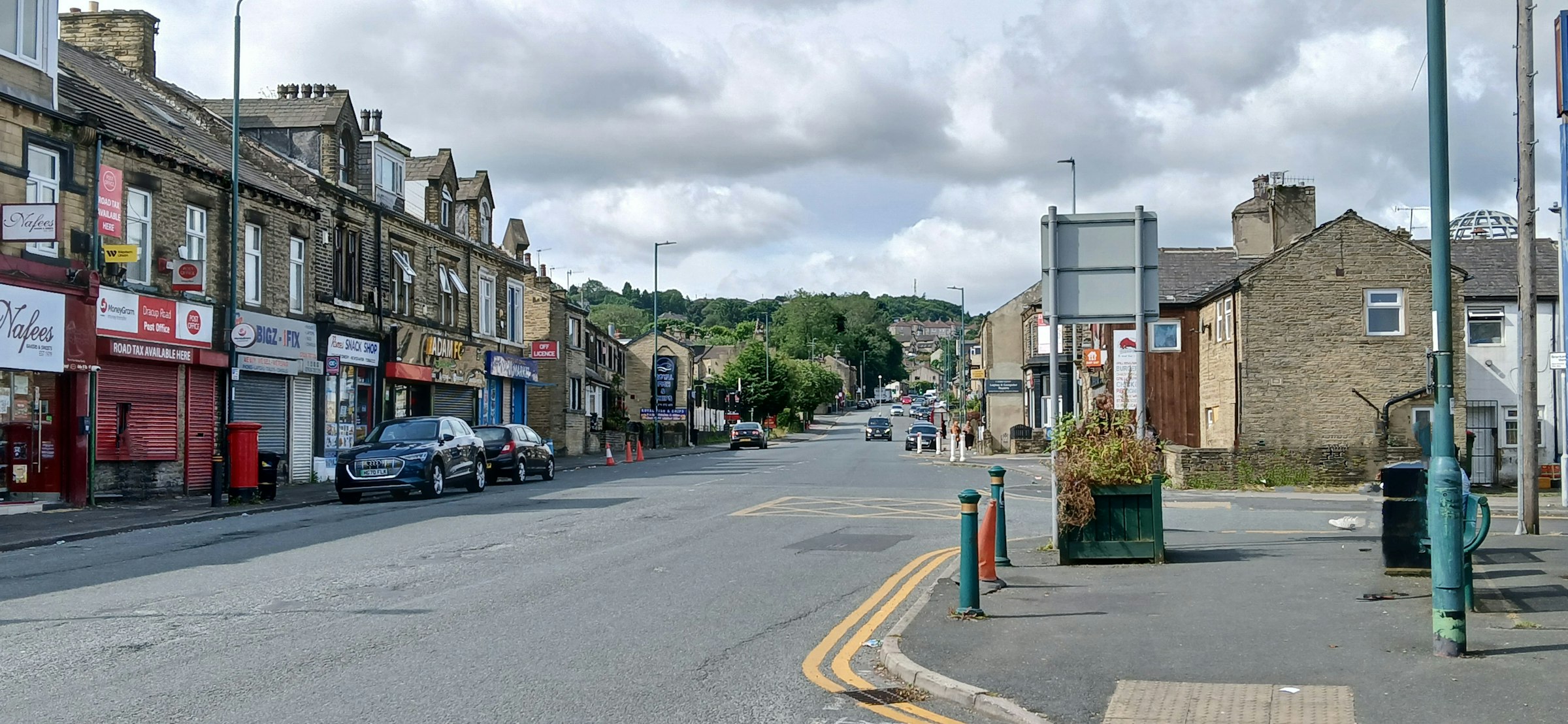 A busy high street lined with independent shops — the physical surfaces Adprio measures.